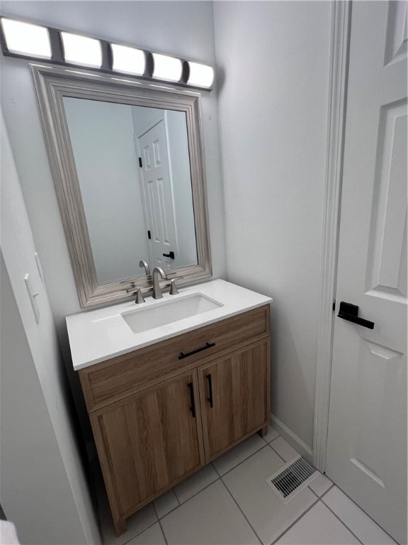 bathroom with tile patterned floors and vanity