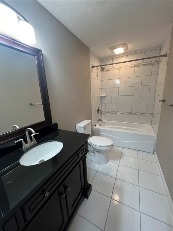 full bathroom featuring tile patterned flooring, tiled shower / bath combo, toilet, and vanity