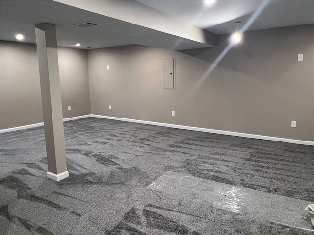 basement with dark carpet and electric panel