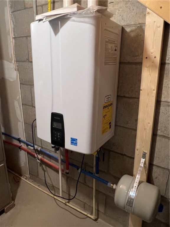 utility room featuring water heater