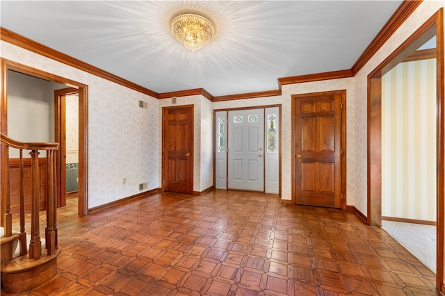 foyer entrance with ornamental molding and a notable chandelier