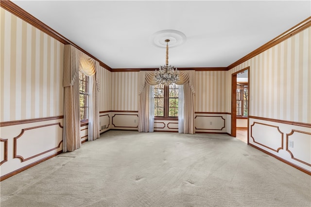 empty room with carpet flooring, crown molding, and an inviting chandelier