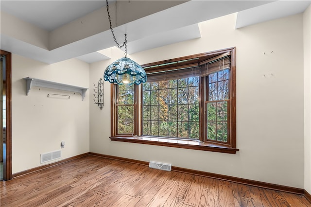 unfurnished dining area featuring light wood-type flooring