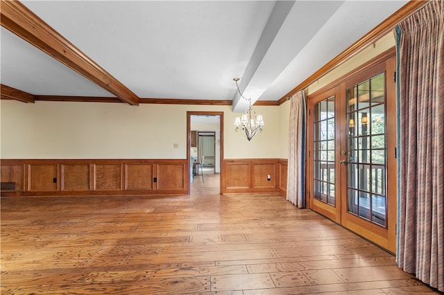 interior space with french doors, ornamental molding, beam ceiling, light hardwood / wood-style flooring, and a notable chandelier