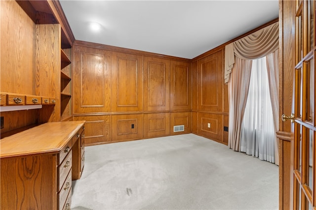 carpeted office space with wood walls