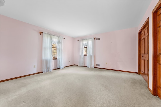 unfurnished room featuring light colored carpet