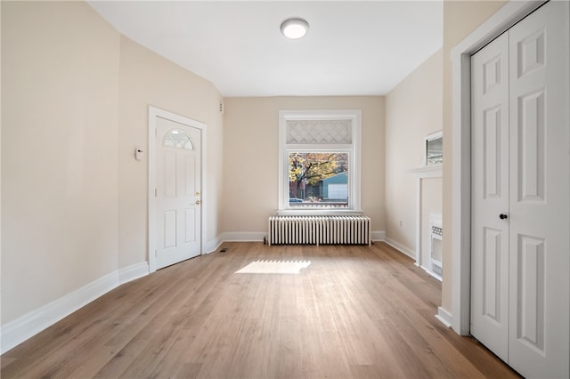 interior space featuring radiator and light hardwood / wood-style flooring