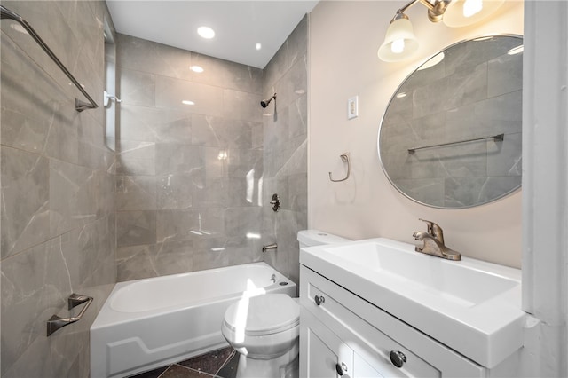 full bathroom with tile patterned flooring, vanity, toilet, and tiled shower / bath