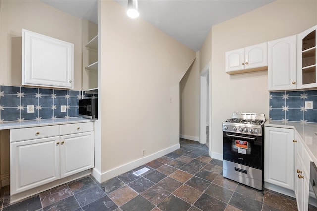 kitchen featuring white cabinetry, decorative backsplash, and stainless steel range with gas cooktop