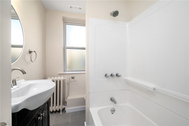 bathroom featuring bathing tub / shower combination, tile patterned floors, radiator heating unit, and sink