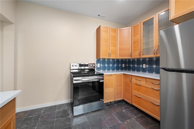 kitchen with backsplash, light brown cabinets, and stainless steel appliances