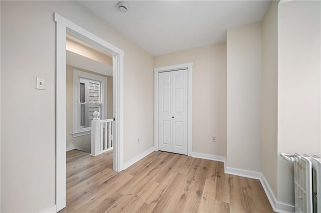 unfurnished room featuring light hardwood / wood-style floors and radiator