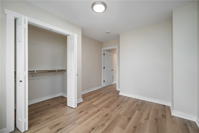 unfurnished bedroom featuring a closet and light hardwood / wood-style flooring