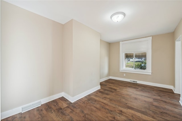 spare room featuring dark hardwood / wood-style floors