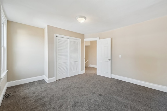 unfurnished bedroom with carpet flooring and a closet