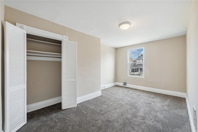 unfurnished bedroom featuring dark colored carpet