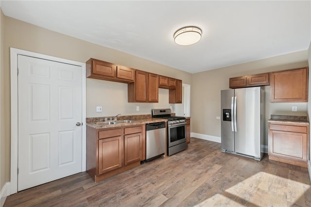 kitchen featuring sink, wood-type flooring, and stainless steel appliances