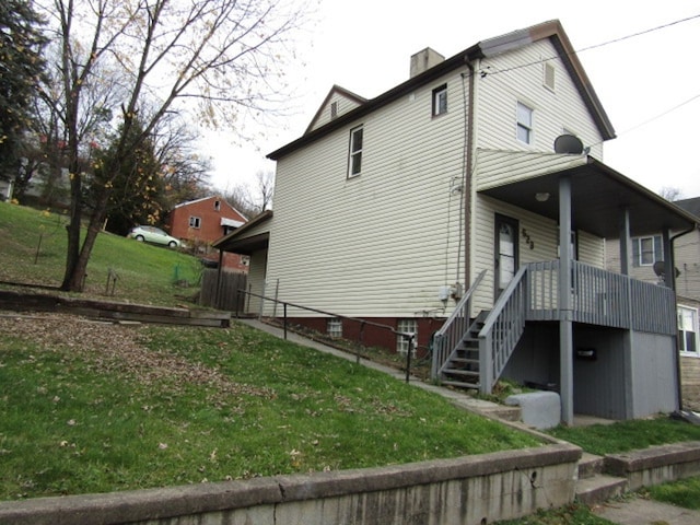 view of side of home featuring a lawn