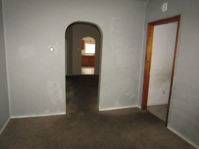 corridor featuring dark carpet