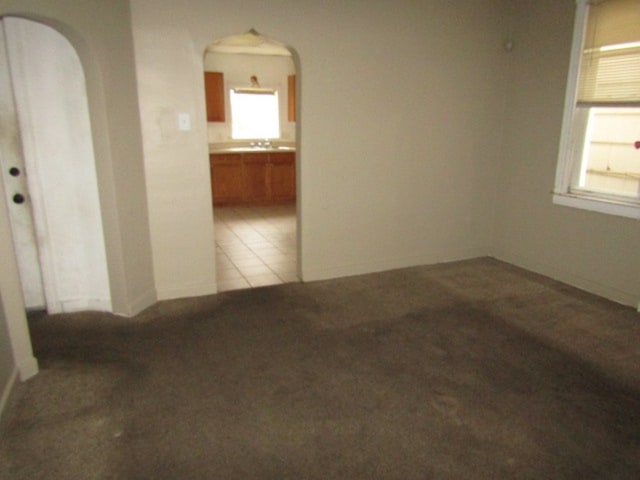 tiled spare room featuring sink