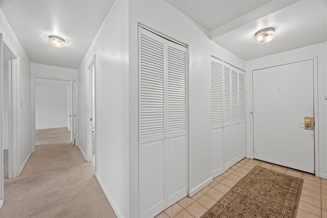 view of carpeted foyer entrance