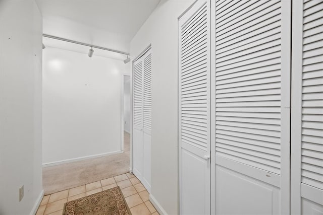 hall with light tile patterned floors