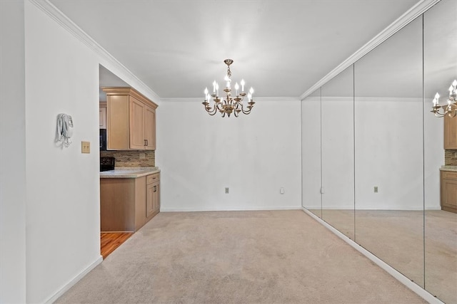 unfurnished dining area with light carpet, an inviting chandelier, and ornamental molding