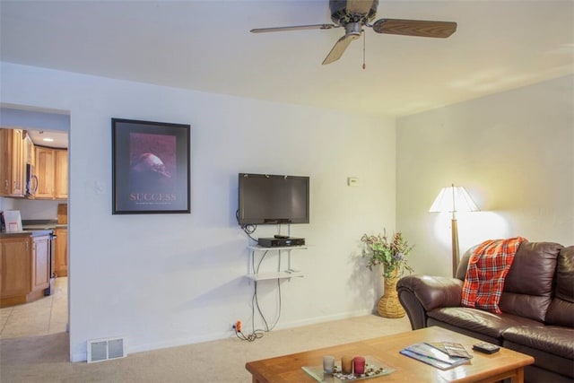 living room with light carpet and ceiling fan