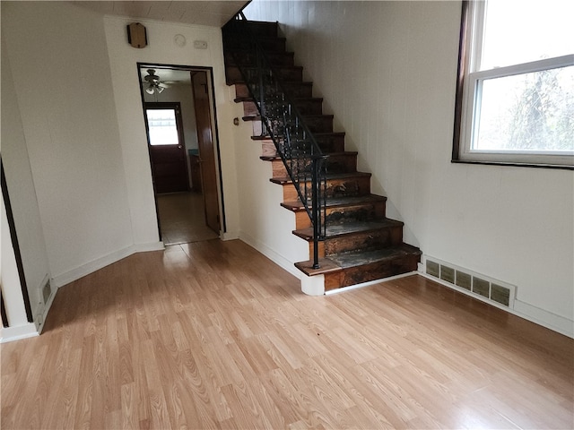 stairway featuring hardwood / wood-style flooring and ceiling fan