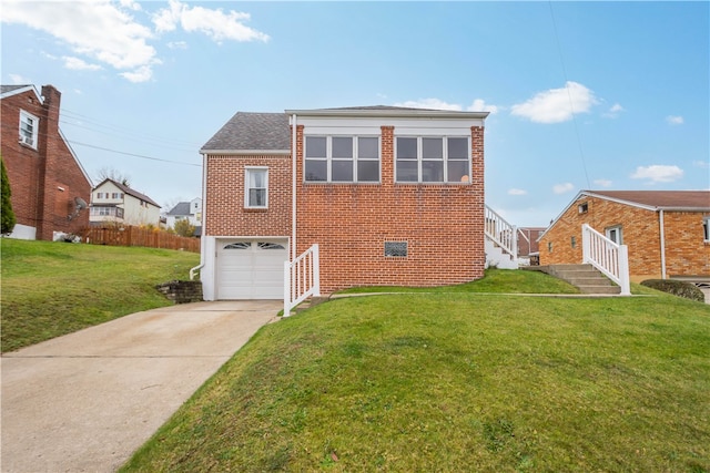 view of front of property with a garage and a front yard