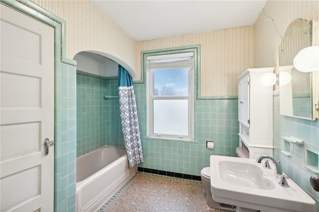 full bathroom with sink, tile patterned floors, toilet, shower / tub combo, and tile walls