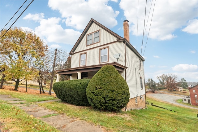 view of side of home with a lawn