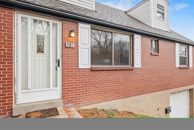 view of exterior entry with a garage