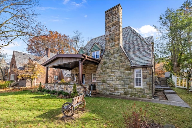 rear view of property featuring a yard