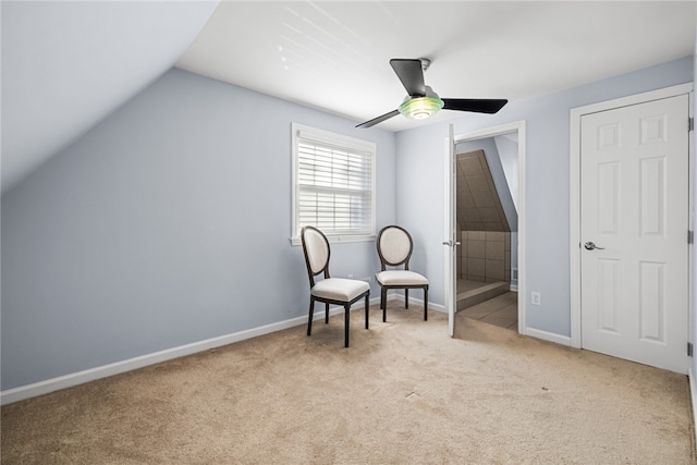 living area featuring light carpet, ceiling fan, and lofted ceiling