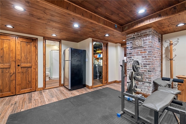 exercise area featuring wood-type flooring and wooden ceiling