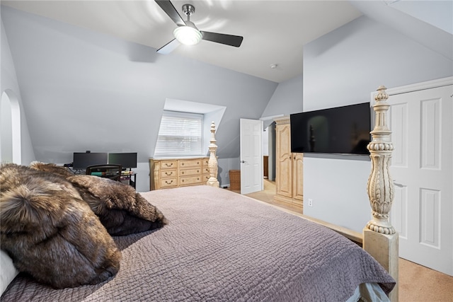 carpeted bedroom with ceiling fan and vaulted ceiling