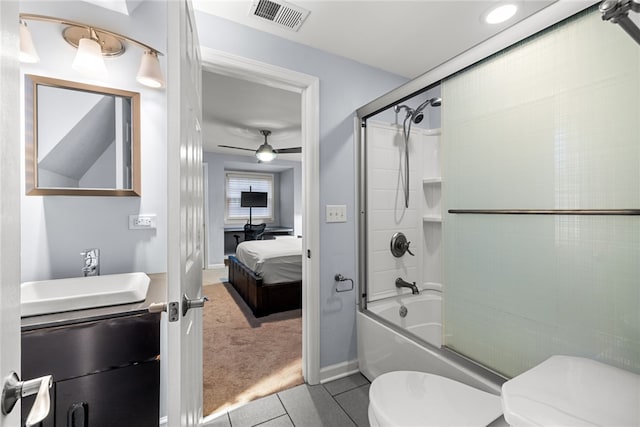 full bathroom featuring combined bath / shower with glass door, tile patterned floors, vanity, ceiling fan, and toilet