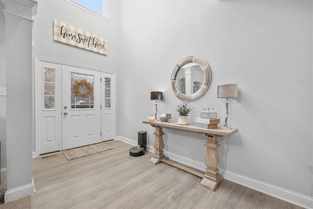 foyer featuring a high ceiling and light hardwood / wood-style floors