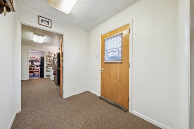 hallway featuring carpet and crown molding