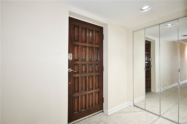 foyer entrance featuring light tile patterned flooring