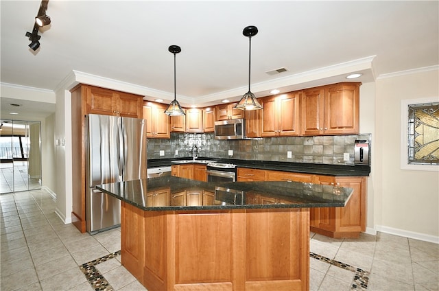 kitchen with crown molding, a kitchen island, decorative light fixtures, and appliances with stainless steel finishes