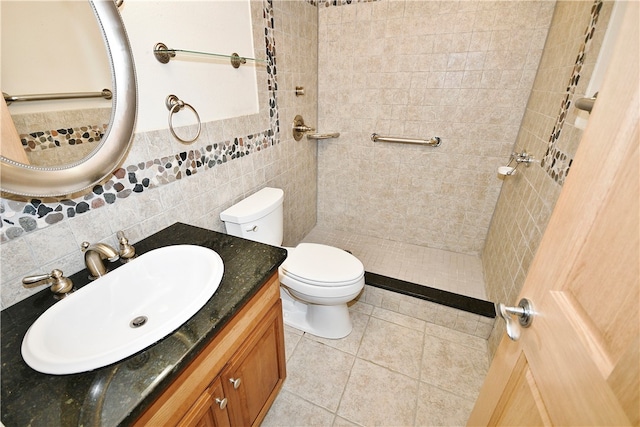 bathroom with tile patterned flooring, toilet, decorative backsplash, vanity, and tile walls