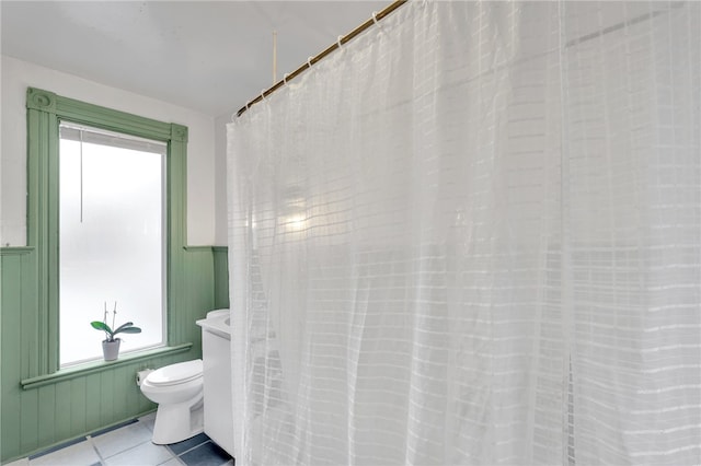 bathroom with tile patterned flooring and toilet