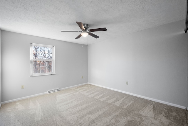 unfurnished room featuring ceiling fan, a textured ceiling, and carpet flooring