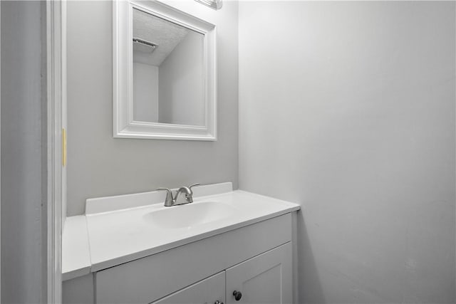 bathroom with a textured ceiling and vanity