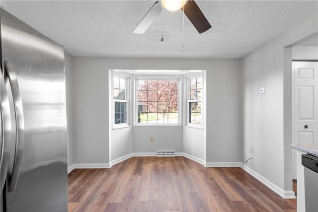 unfurnished room featuring ceiling fan, a textured ceiling, and hardwood / wood-style flooring