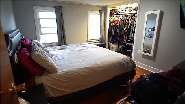 bedroom with hardwood / wood-style floors and a closet