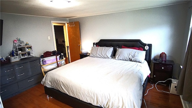 bedroom with dark hardwood / wood-style flooring