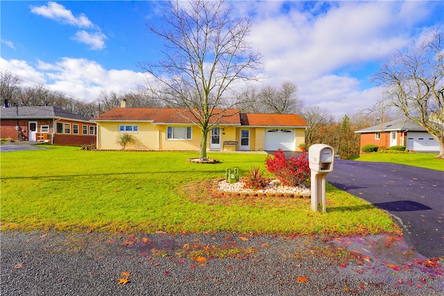 ranch-style home featuring a garage, a front lawn, a chimney, and driveway